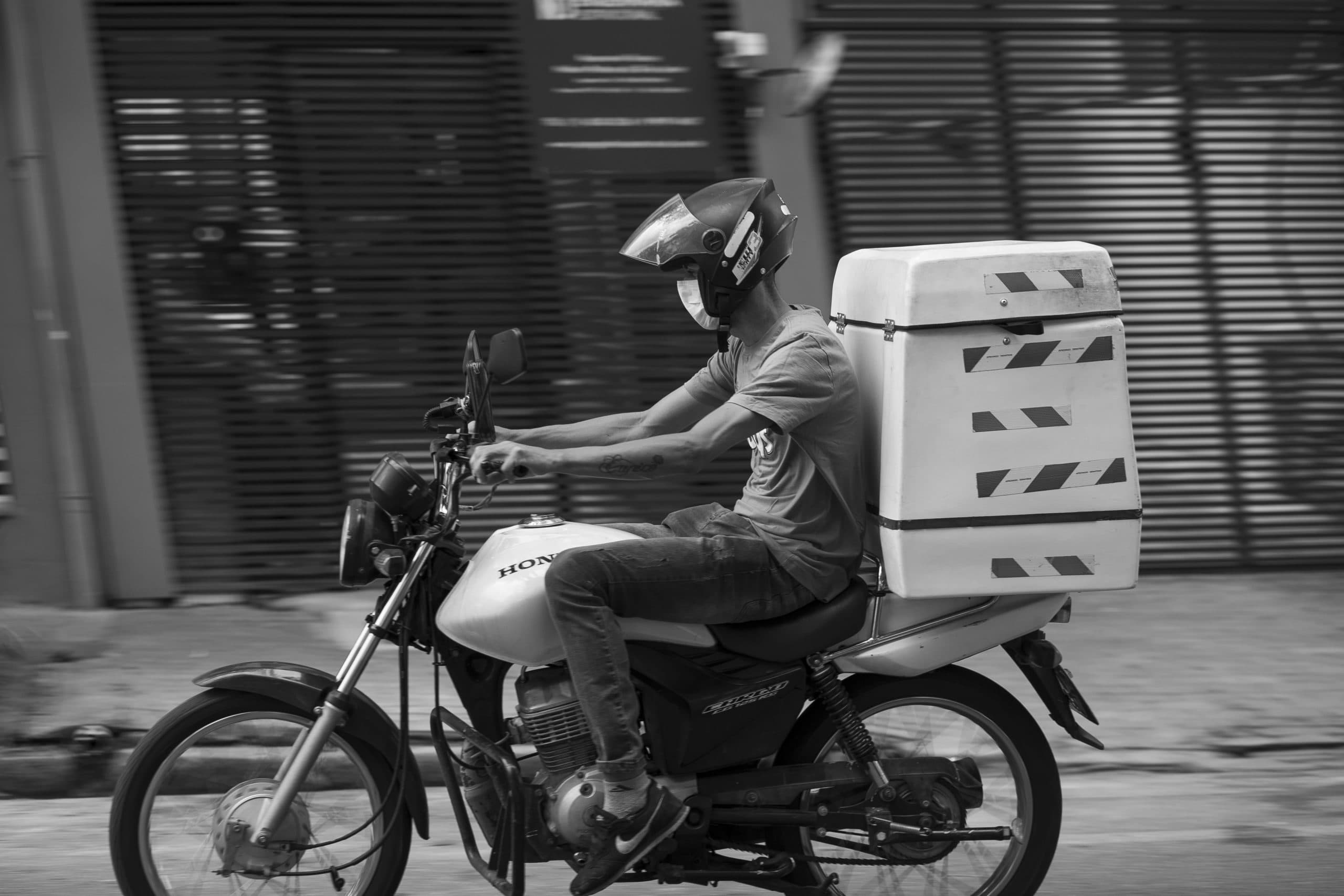 A platform worker rushing through the empty streets of São Paulo during the COVID-19 pandemic